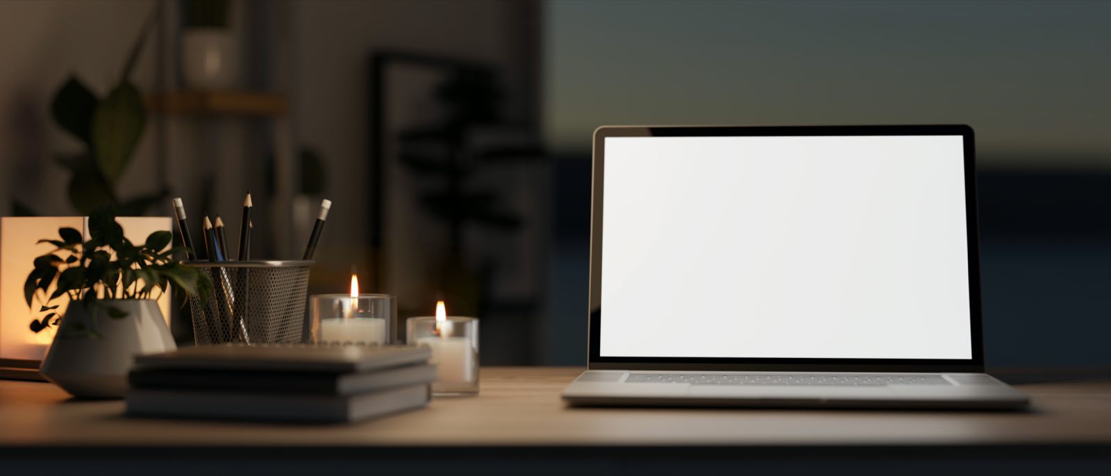 A laptop lit by candles during a power outage