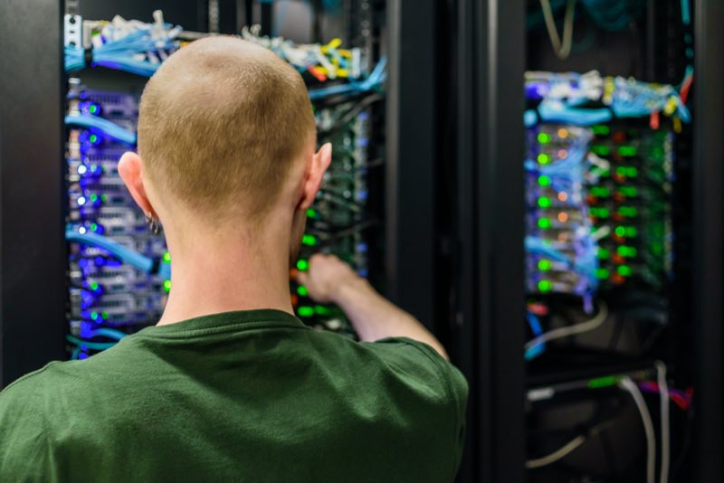 A technician performing maintenance on servers in a data centre